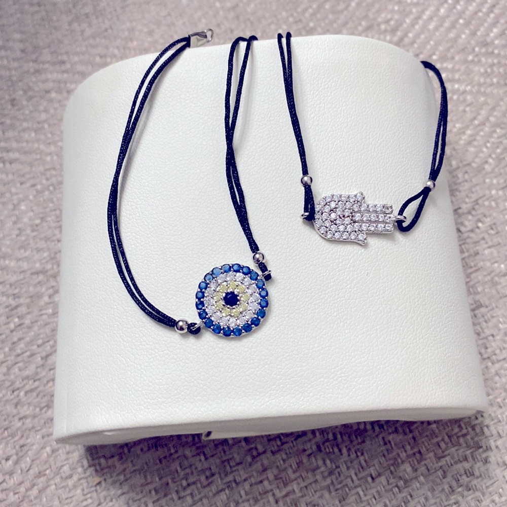 2 bracelets (Hamsa hand and round blue crystal) with string band